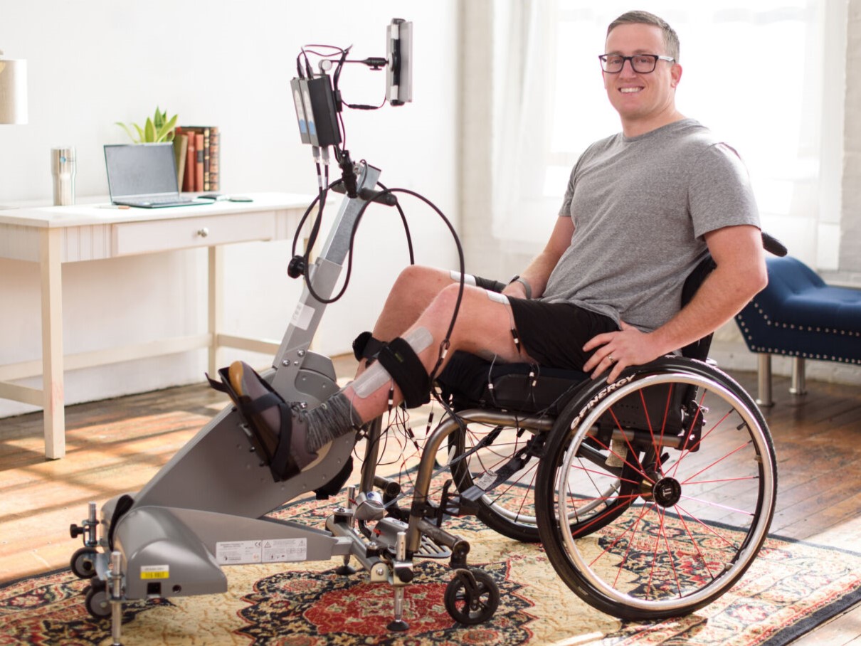 Veteran performing home therapy on the RT300 system in a cozy living room setup